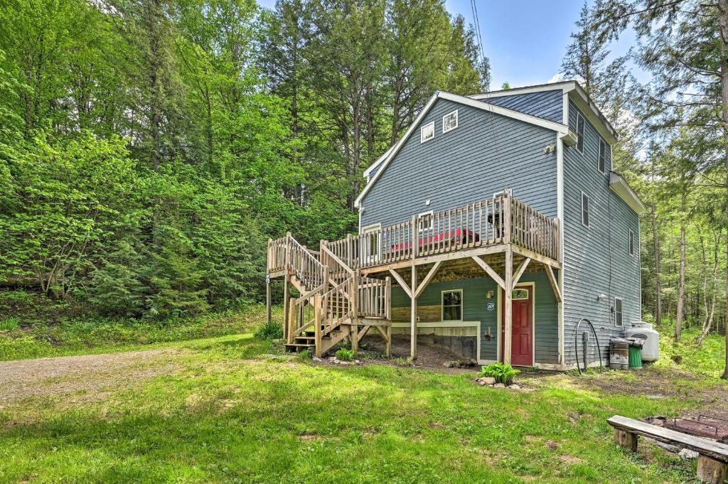 a house with a deck on the side of it at Cabin in the Untouched Woods - 3 Miles to Ski in Jay