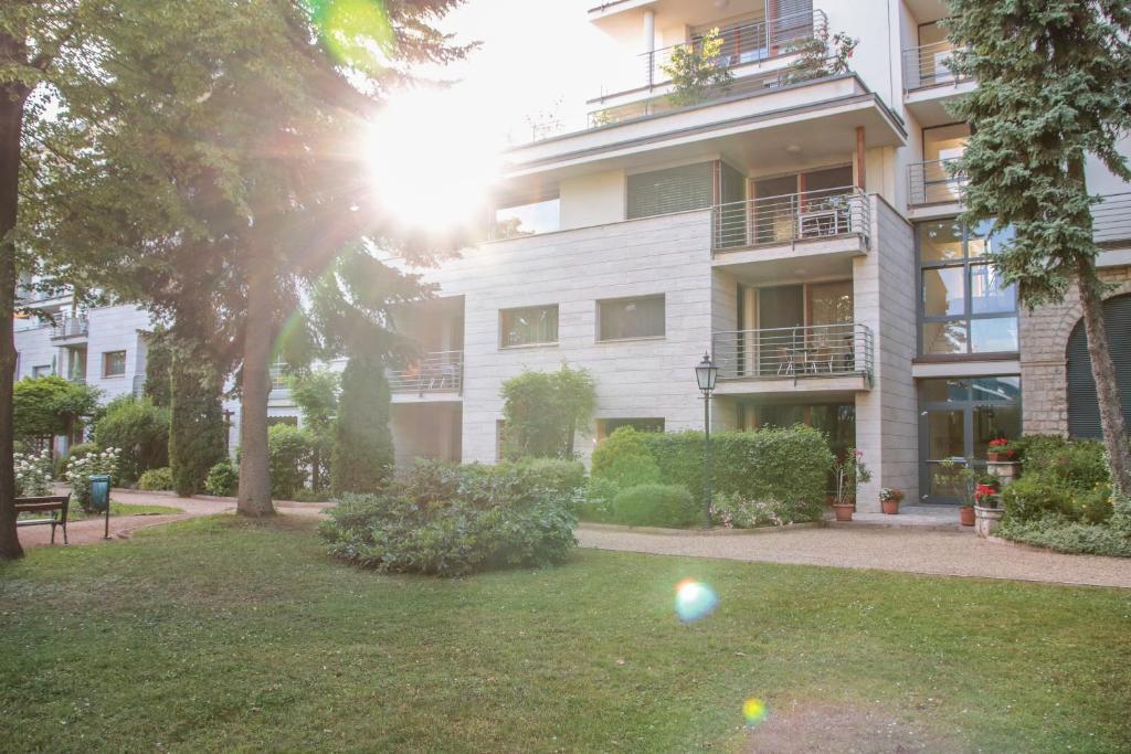 an apartment building with a ball in the yard at The Bluedeck Wellness Apartment in Balatonfüred