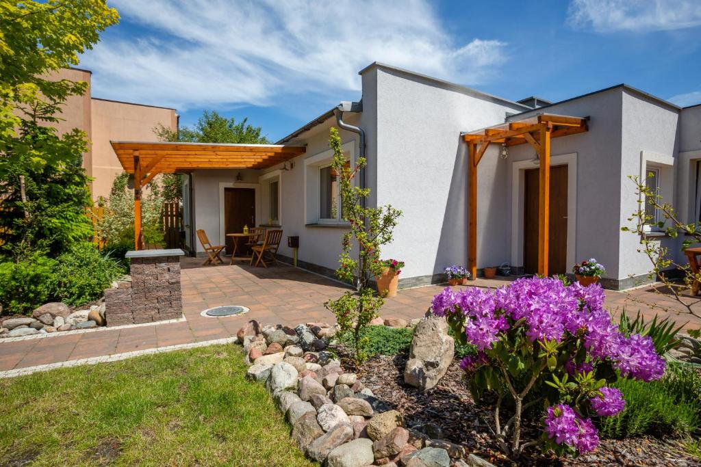 a garden with purple flowers and a house at Holiday Homes Puck Garden Estate in Puck