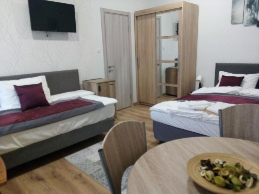 A bed or beds in a room at Hooper's Vendégház