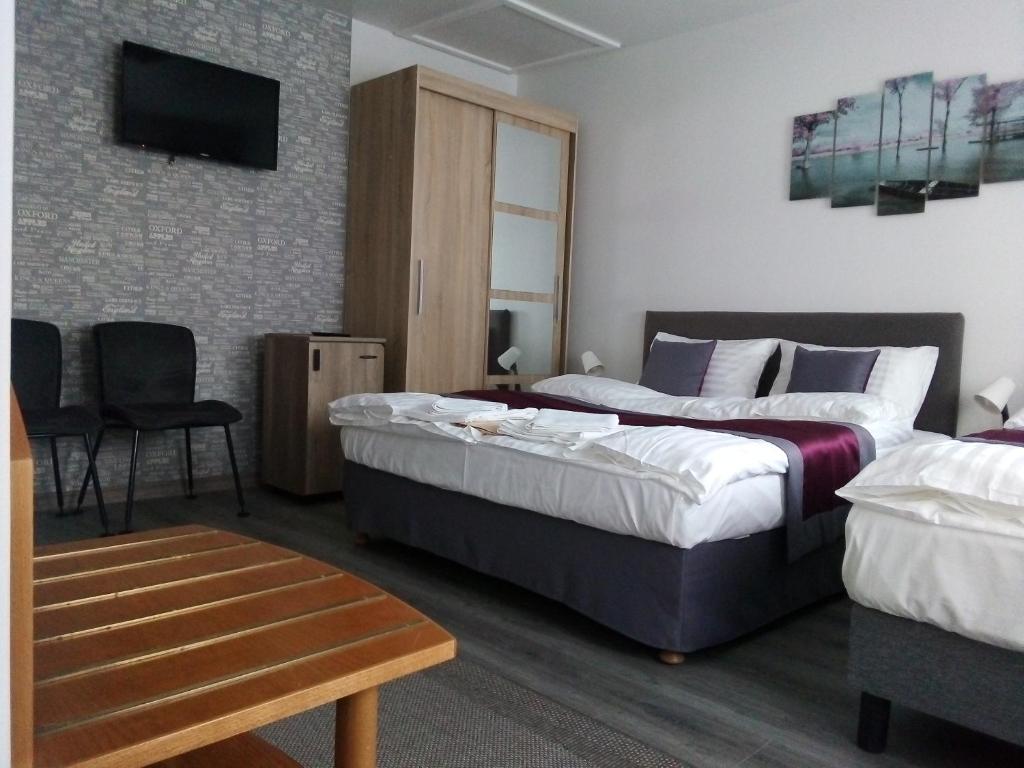 A bed or beds in a room at Hooper's Vendégház
