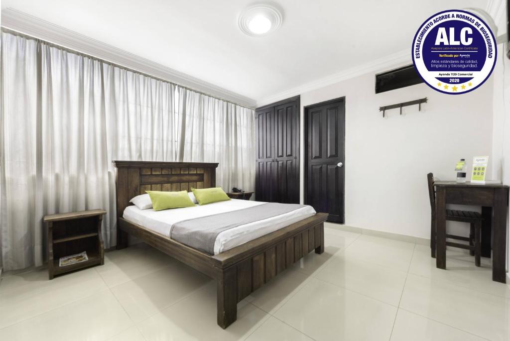 a bedroom with a bed and a desk in it at Ayenda 1120 Hotel Comercial in Pereira