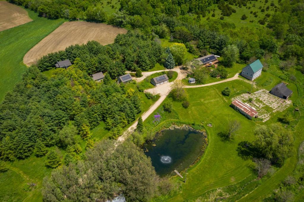 an aerial view of a farm with a house and trees at Hawk Valley Retreat & Cottages in Galena