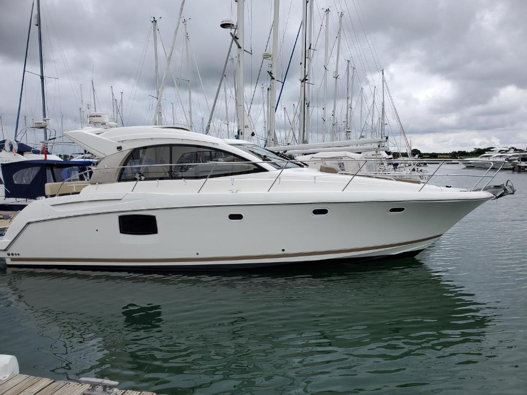 a white boat is docked in the water at Zen Dog Luxury Motor Yacht in Lymington
