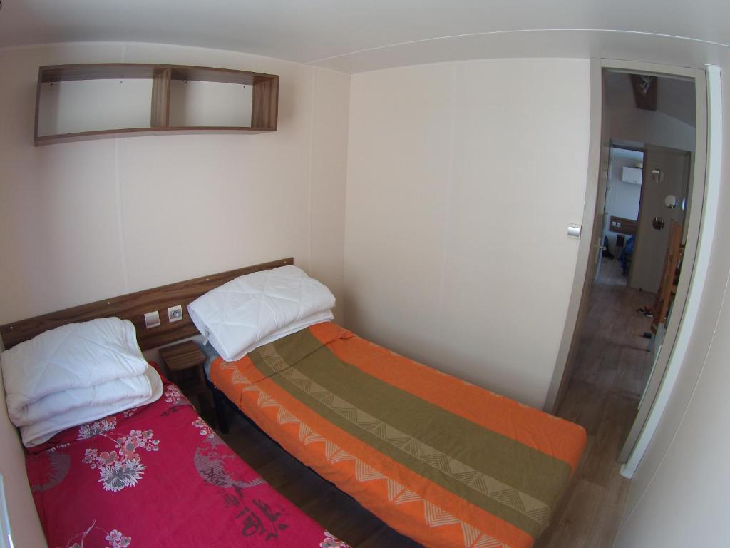 a small room with two beds in it at La Carabasse / Mazet 69 in Vias
