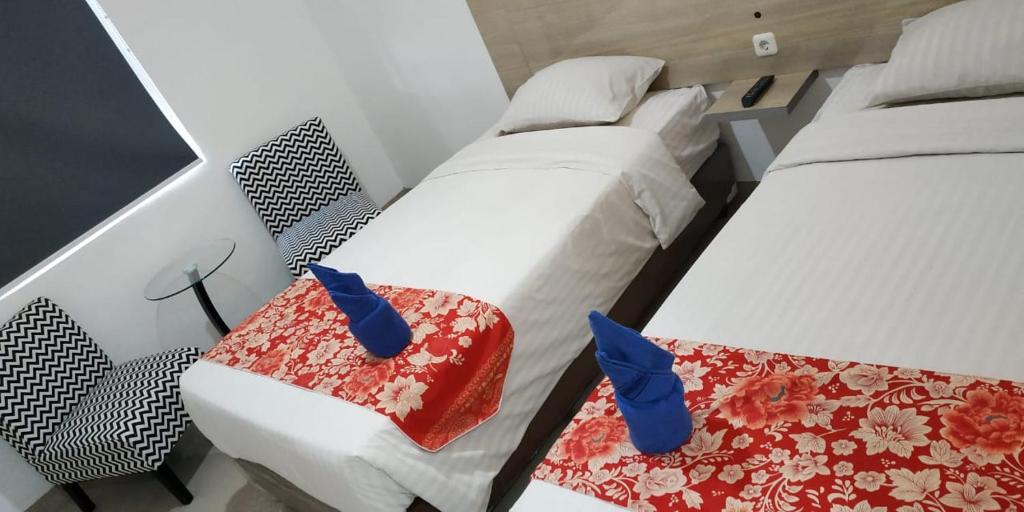 Postel nebo postele na pokoji v ubytování Mel's Inn Manado