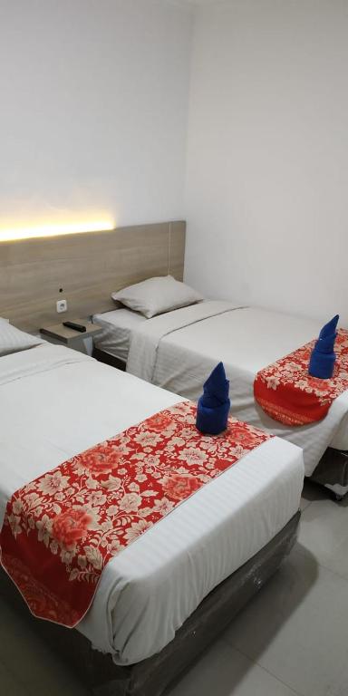 Postel nebo postele na pokoji v ubytování Mel's Inn Manado