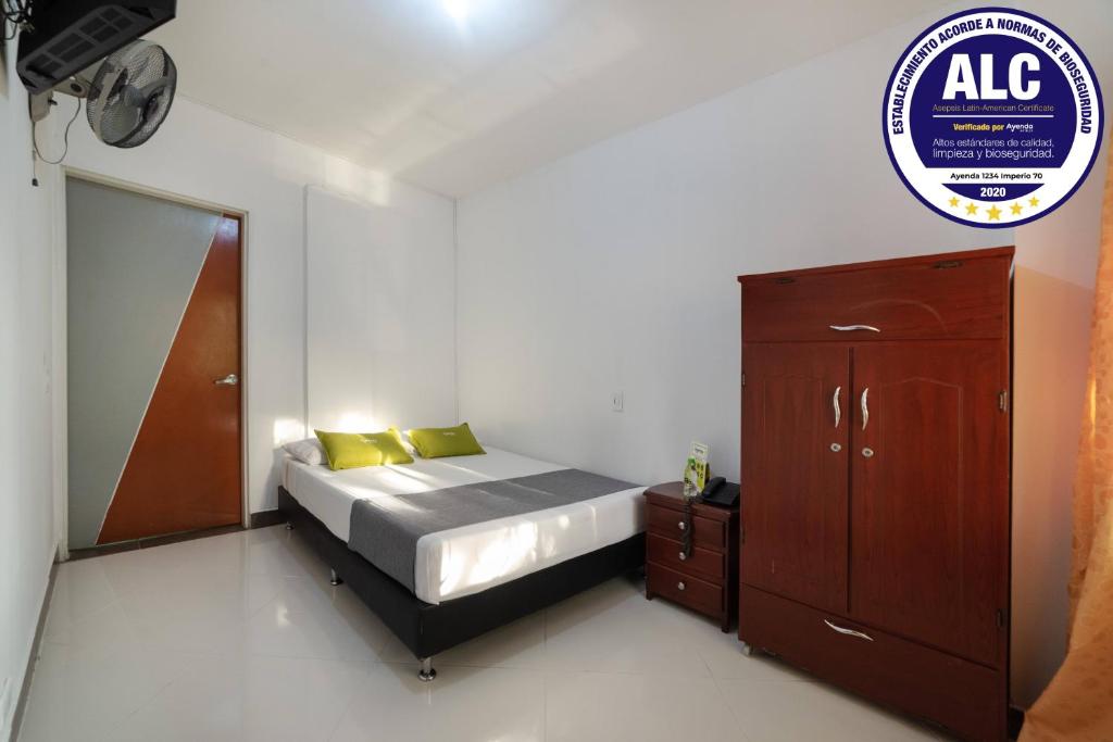 a small bedroom with a bed and a dresser at Ayenda 1234 Imperio 70 in Medellín