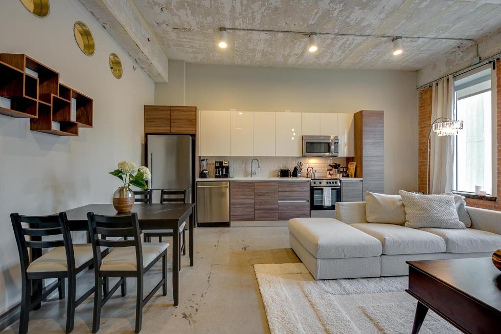 a kitchen and living room with a couch and a table at Butler Brothers Building Suites in Dallas