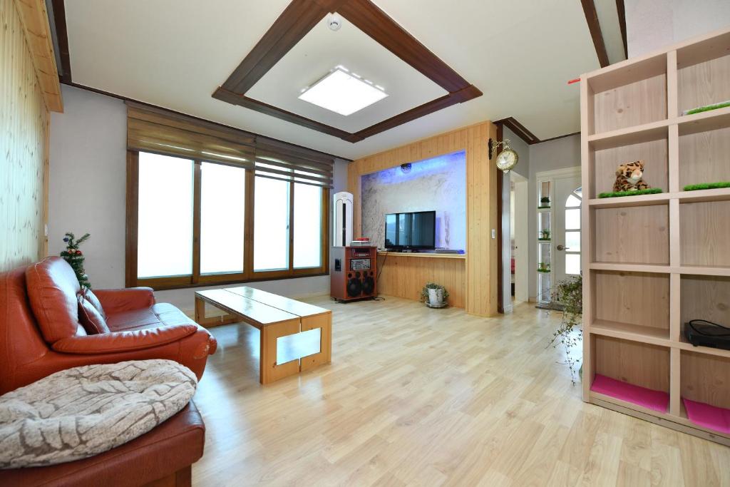 a living room with a couch and a table at Sokcho Daemyung Pension in Sokcho