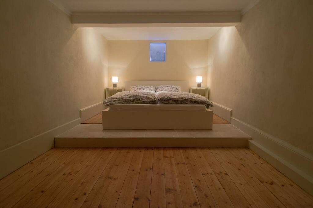 ein Schlafzimmer mit einem Bett mit zwei Lichtern an der Wand in der Unterkunft Wohnung im Herzen von Ludwigsburg in Ludwigsburg