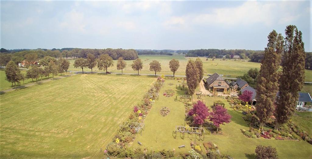 an aerial view of a large field with a house at B&B Johannahoeve Veluwe in Hall
