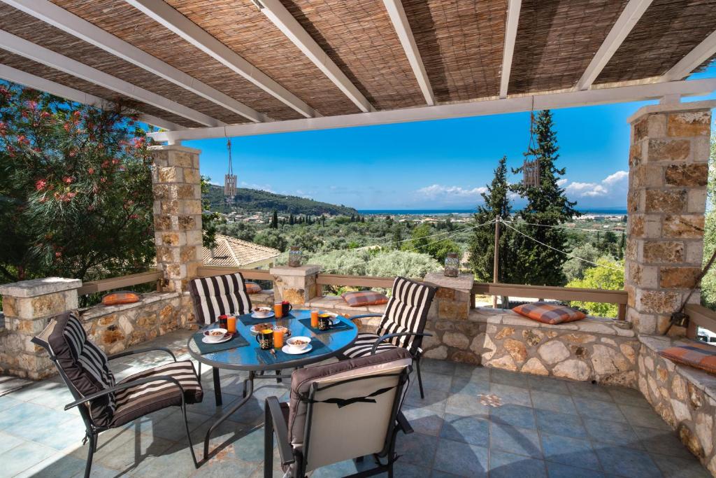 a patio with a table and chairs with a view at Villa Gerasimoula in Lefkada