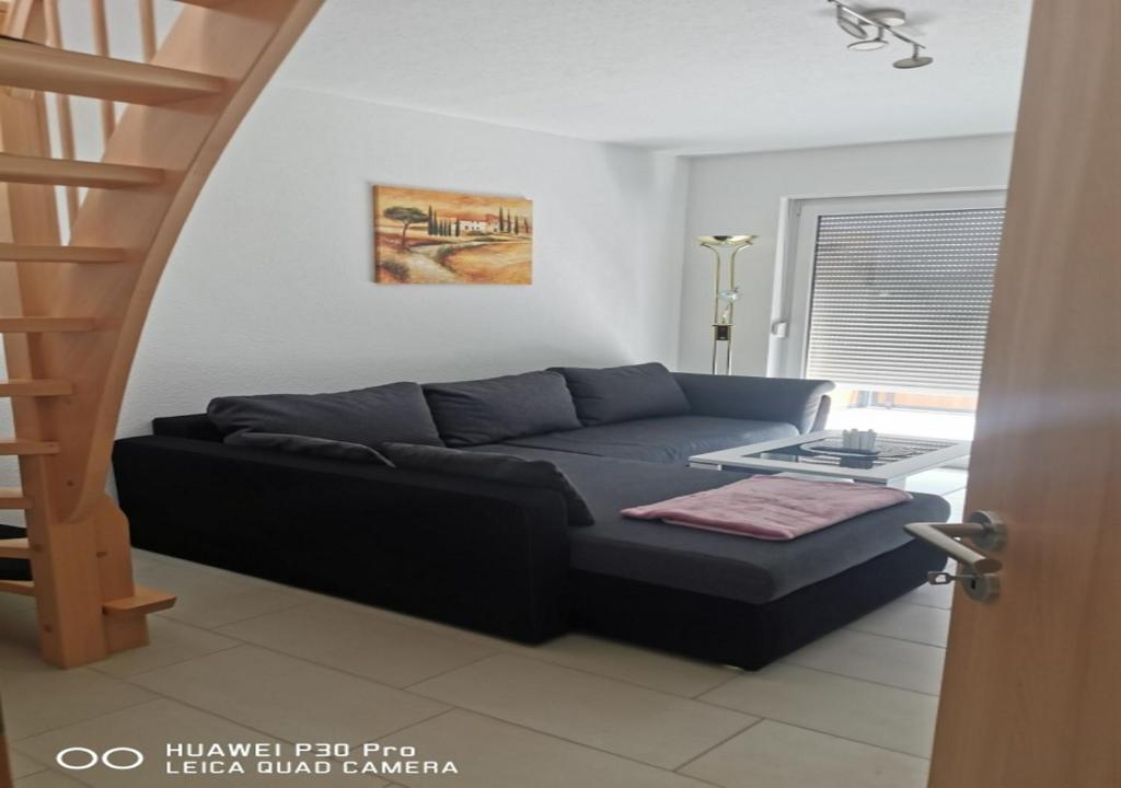 a living room with a couch and a table at Gästewohnung 17 in Oschersleben