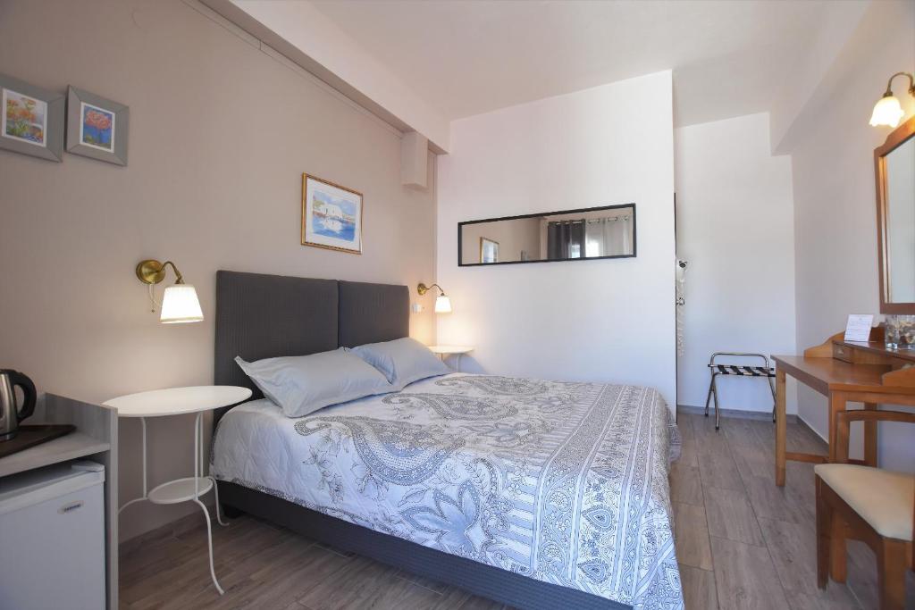Postel nebo postele na pokoji v ubytování Rodakas Hotel