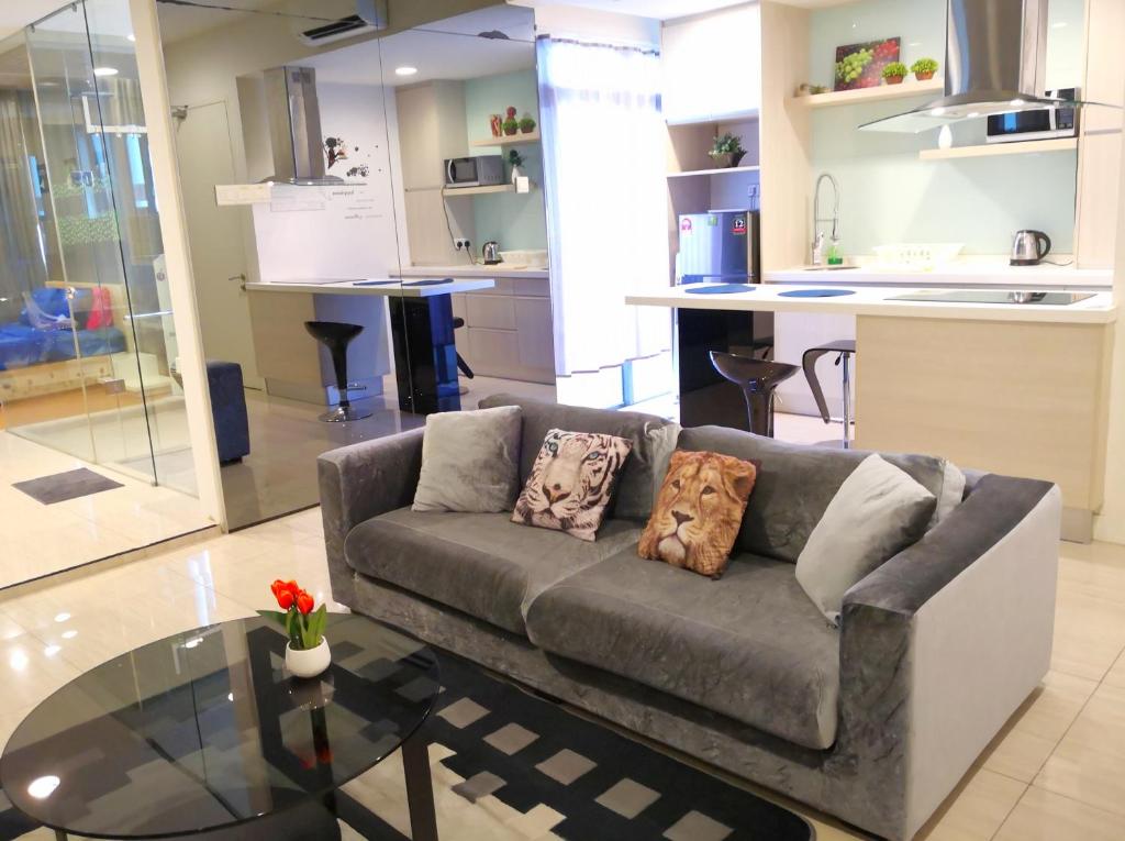 a living room with a couch and a glass table at Eve Suite in Petaling Jaya