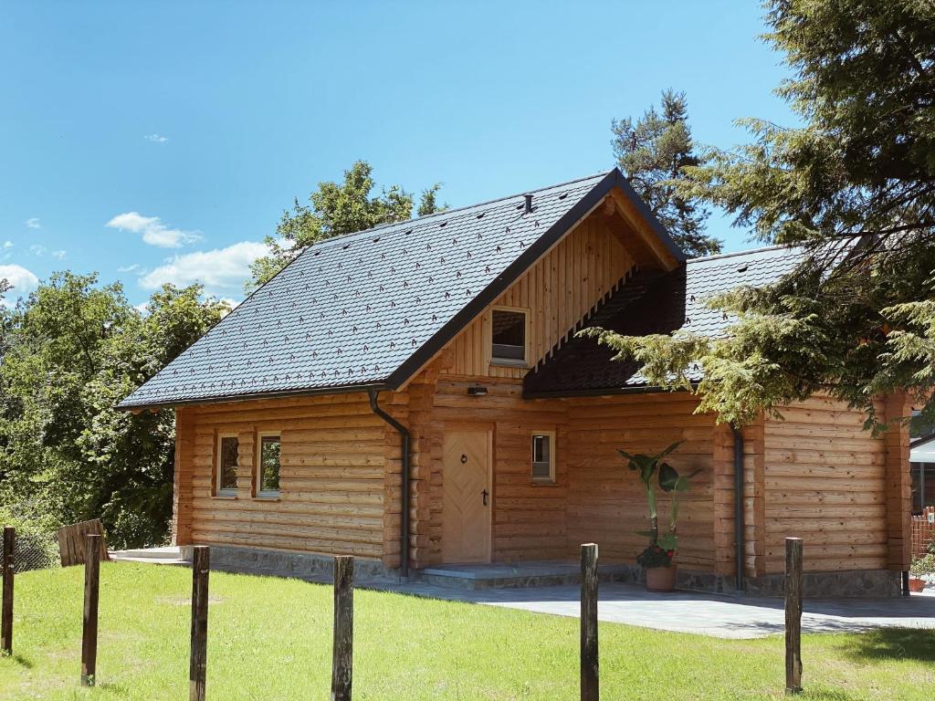 a log cabin with a gambrel roof at Log House Natura in Radovljica