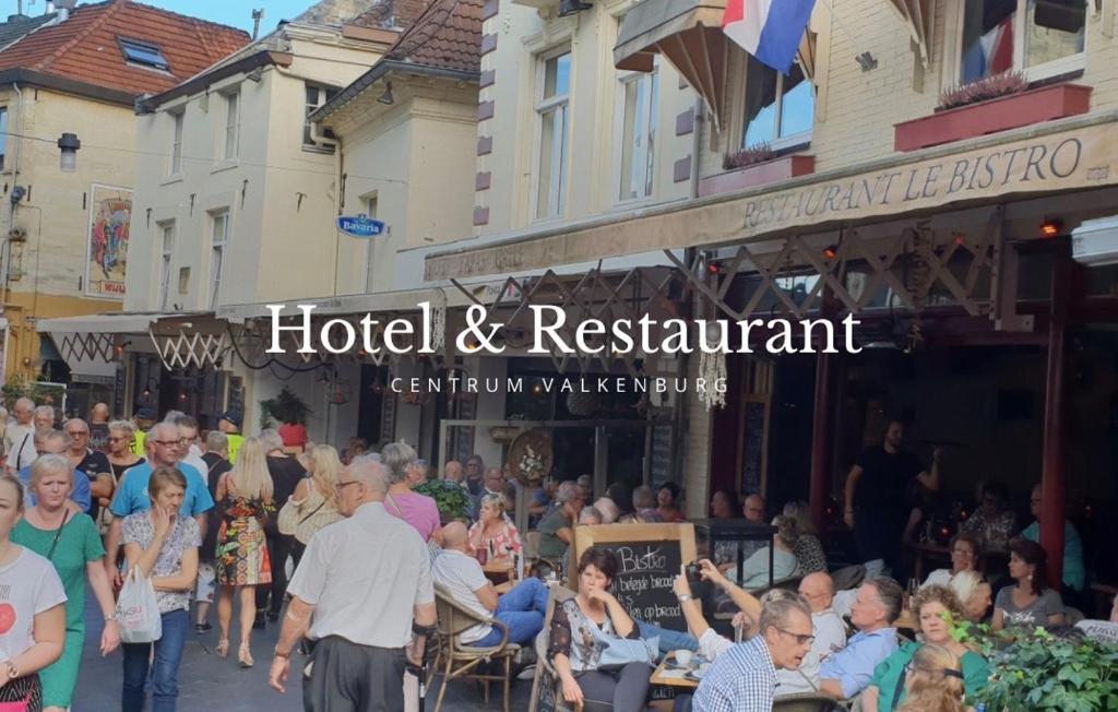 a large crowd of people walking down a street at Le Bistro in Valkenburg