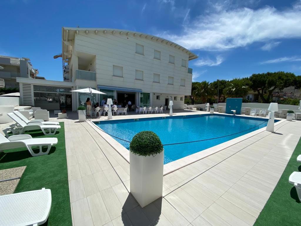 einem Pool vor einem Gebäude in der Unterkunft Elite Boutique Hotel in Roseto degli Abruzzi