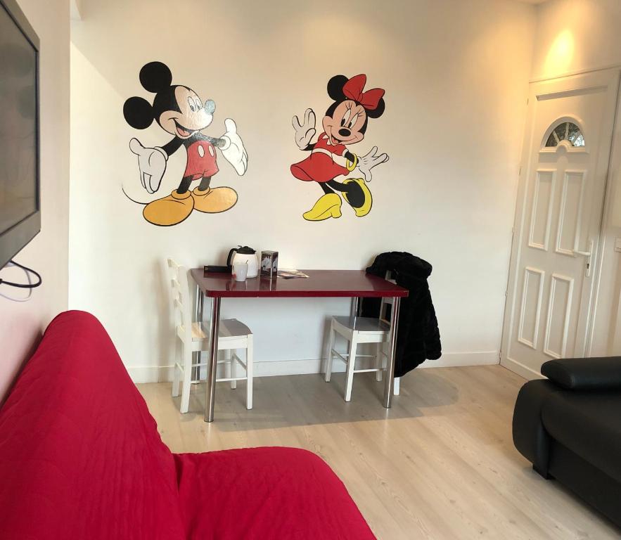 a room with mickey mouse stickers on the wall at Gîtes Poirier Bazin in Montry