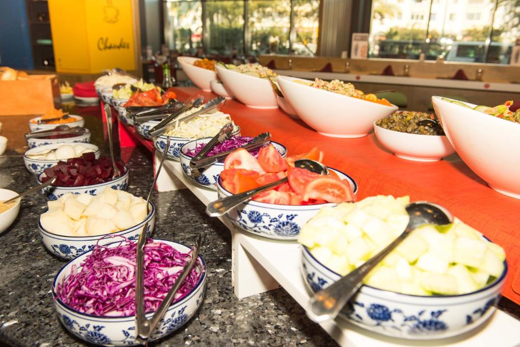 a table topped with bowls of different types of food at ibis Alger Aéroport in Alger