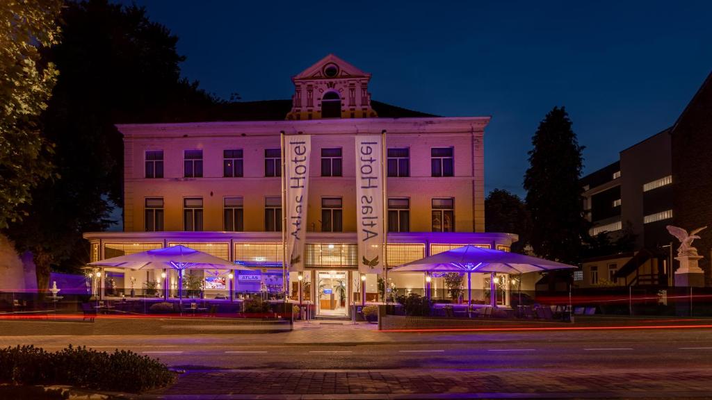 a building with purple lights in front of it at Atlas Hotel in Valkenburg