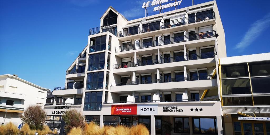 a white building with balconies on the side of it at The Originals Boutique, Hôtel Neptune, Berck-sur-Mer (Inter-Hotel) in Berck-sur-Mer
