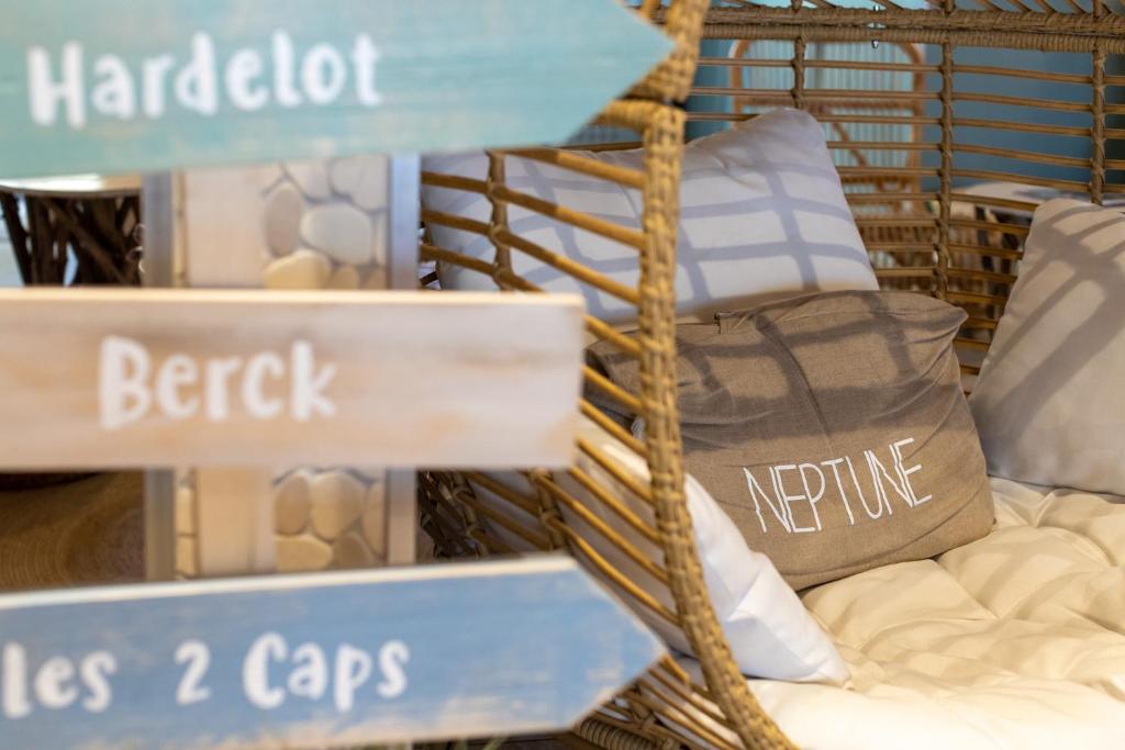 a store window with a bunch of signs and pillows at The Originals Boutique, Hôtel Neptune, Berck-sur-Mer in Berck-sur-Mer