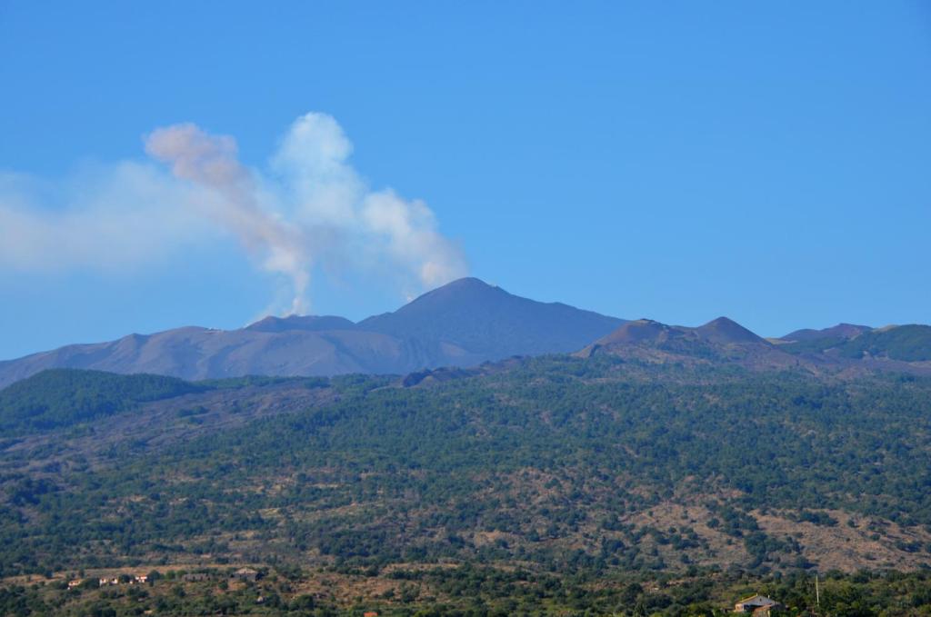 a plume of smoke rises from the mountains at Casale degli Zappini in Castiglione di Sicilia