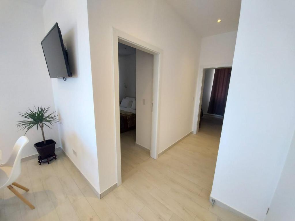 an empty living room with a tv on a wall at Apartments Tanja in Zavalatica