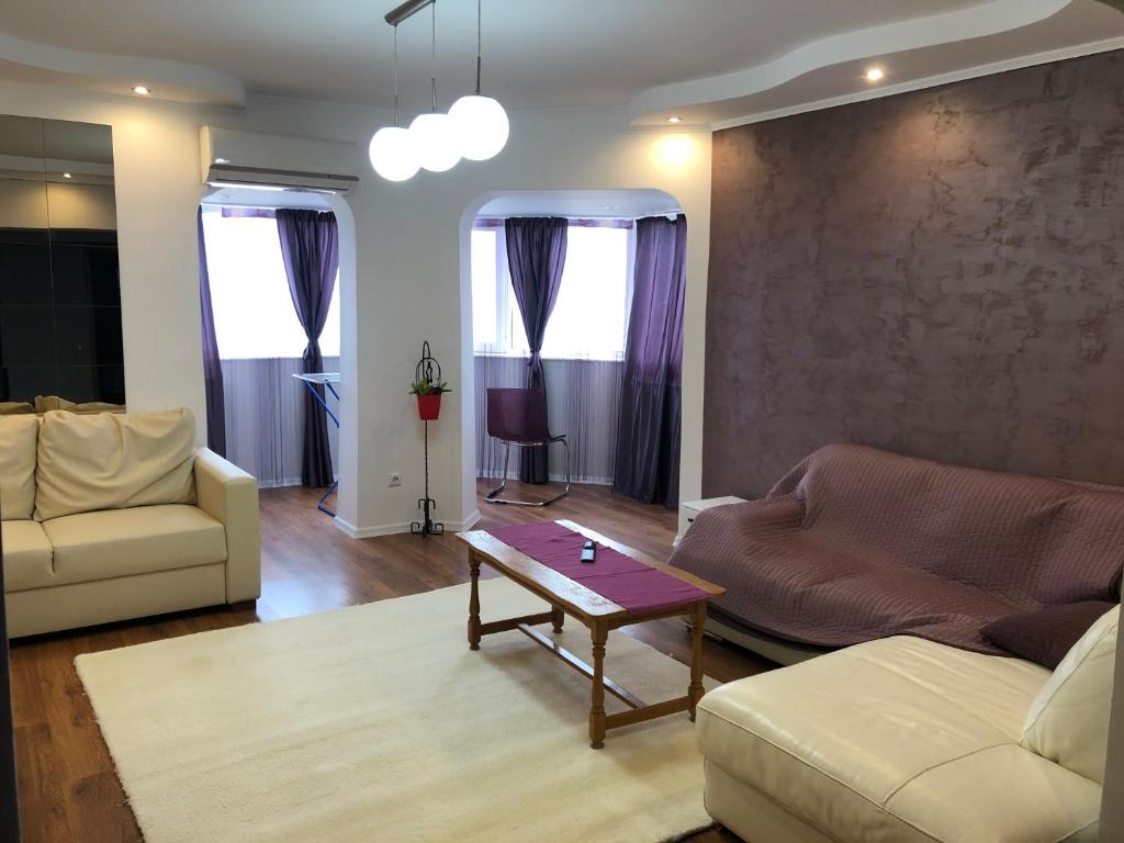 a living room with two couches and a coffee table at Apartament Faleza Nord 3 in Constanţa