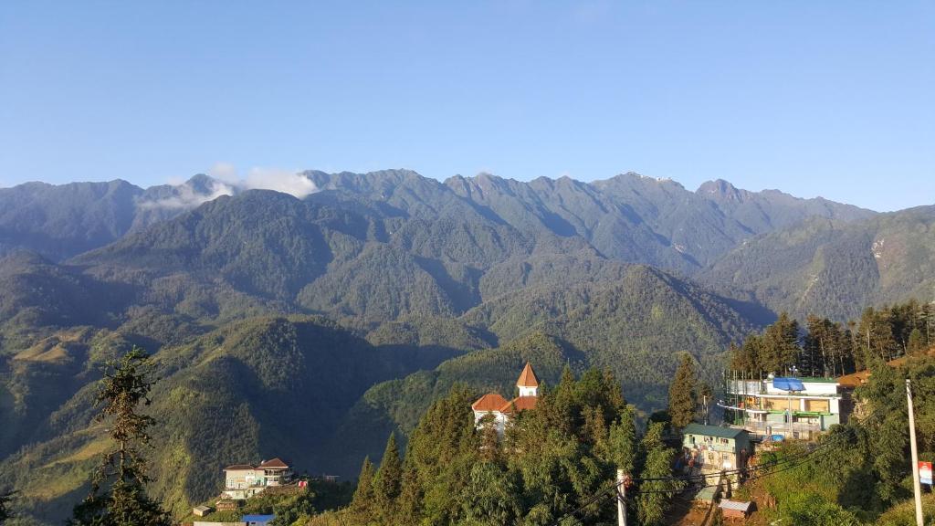 a view of a mountain range with houses and trees at Sapa Scenery Hotel in Sapa