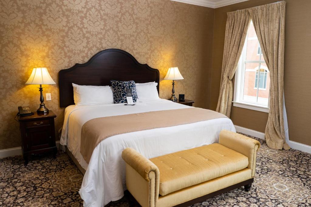 The Mount Vernon Grand Hotel في Mount Vernon: غرفة نوم بسرير وكرسي ونافذة