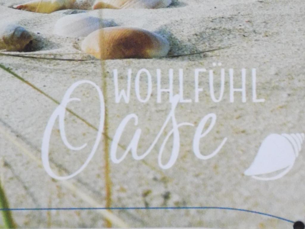 a sign that says wonderful love written in the sand at WOHLFÜHL Oase in Horumersiel