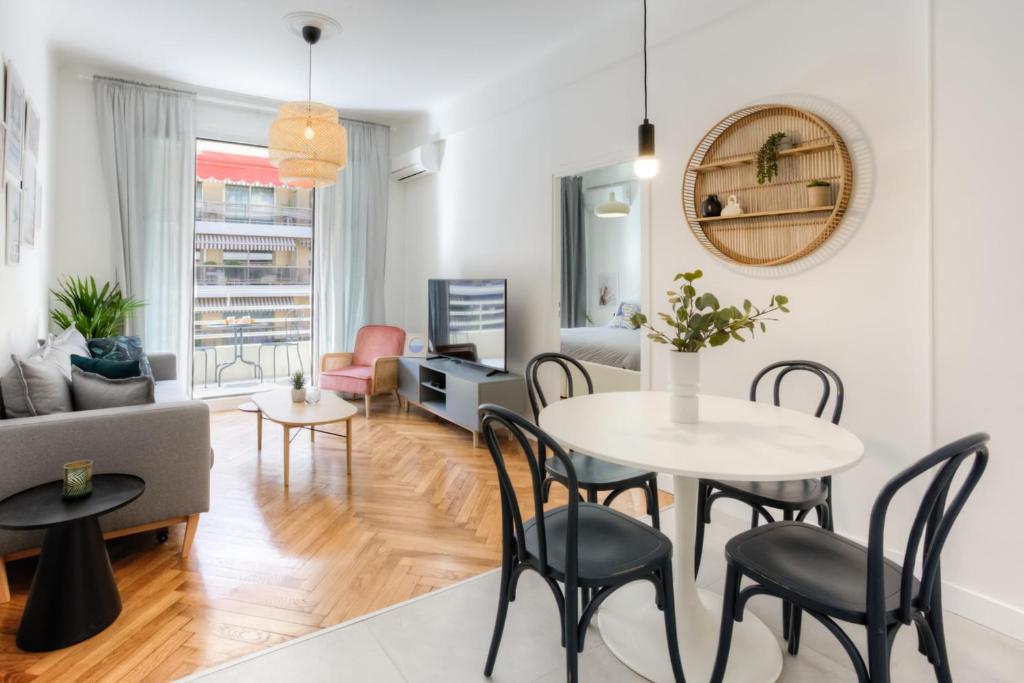 a living room with a table and chairs at #29 Suite Gambetta AC Sea view 2 bedrooms 1min Walk to Promenade &amp; Sea in Nice