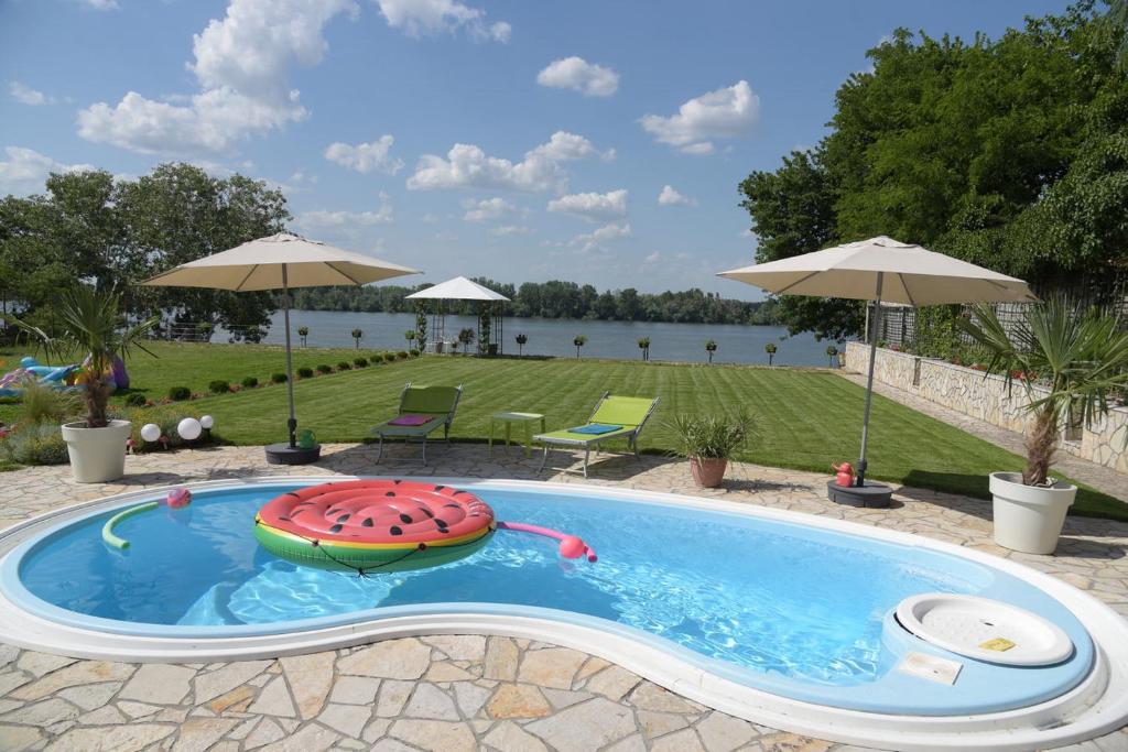 a swimming pool with a life preserver at Vila Lily in Smederevo