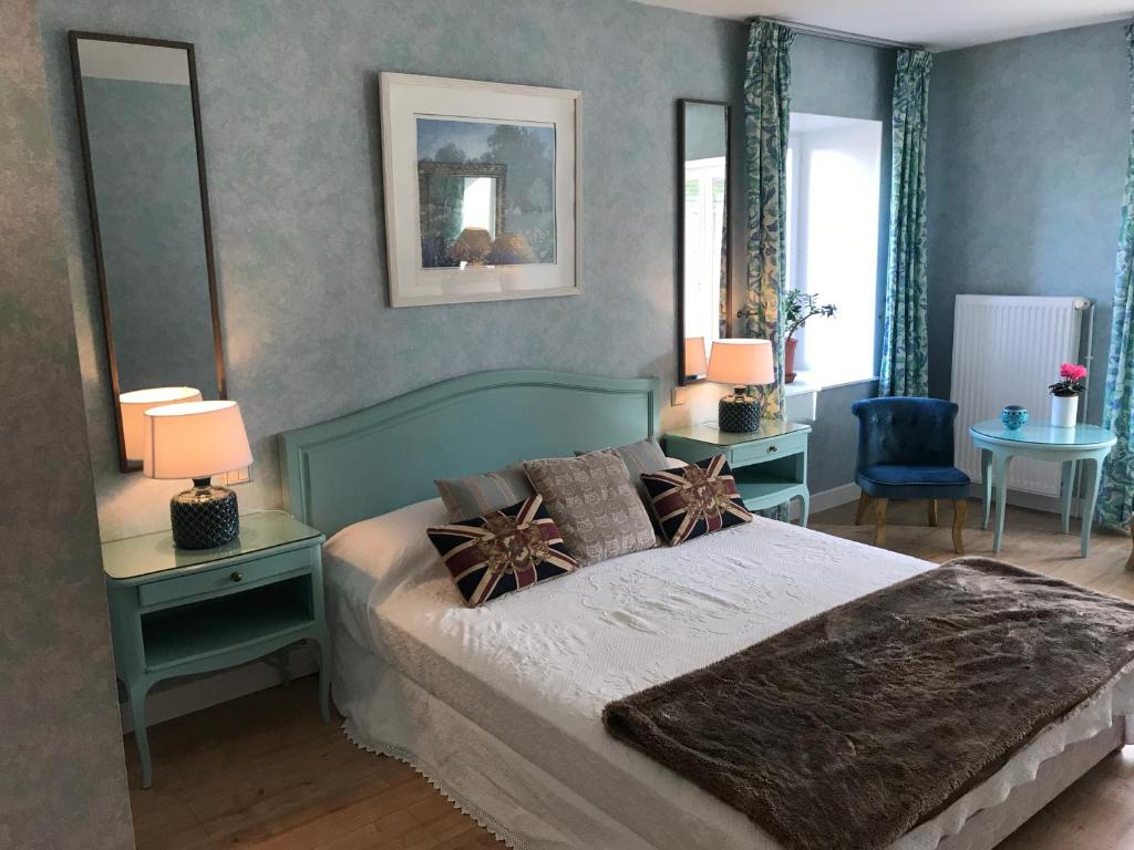 a bedroom with a bed with two tables and two lamps at Ancienne Auberge des Brizards - Morvan (14 personnes) in Quarré-les-Tombes