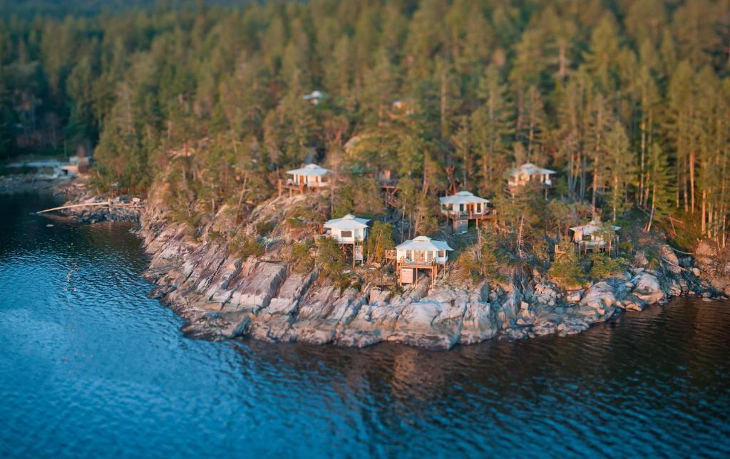 an island in the water with houses on it at Rockwater Secret Cove Resort in Halfmoon Bay