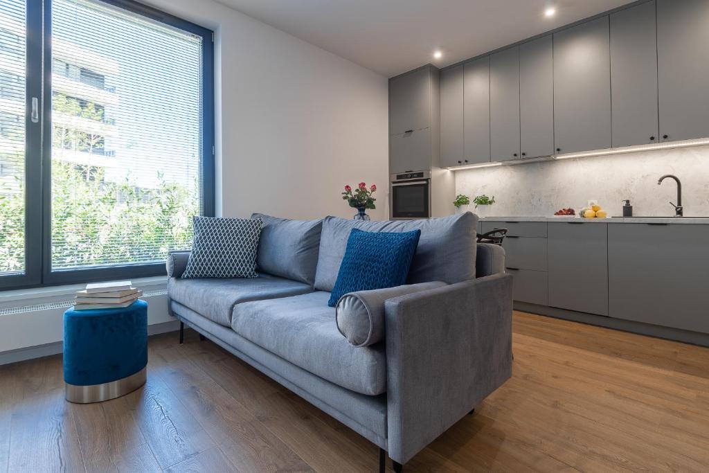 a living room with a couch and a kitchen at Portova Apartament in Gdynia