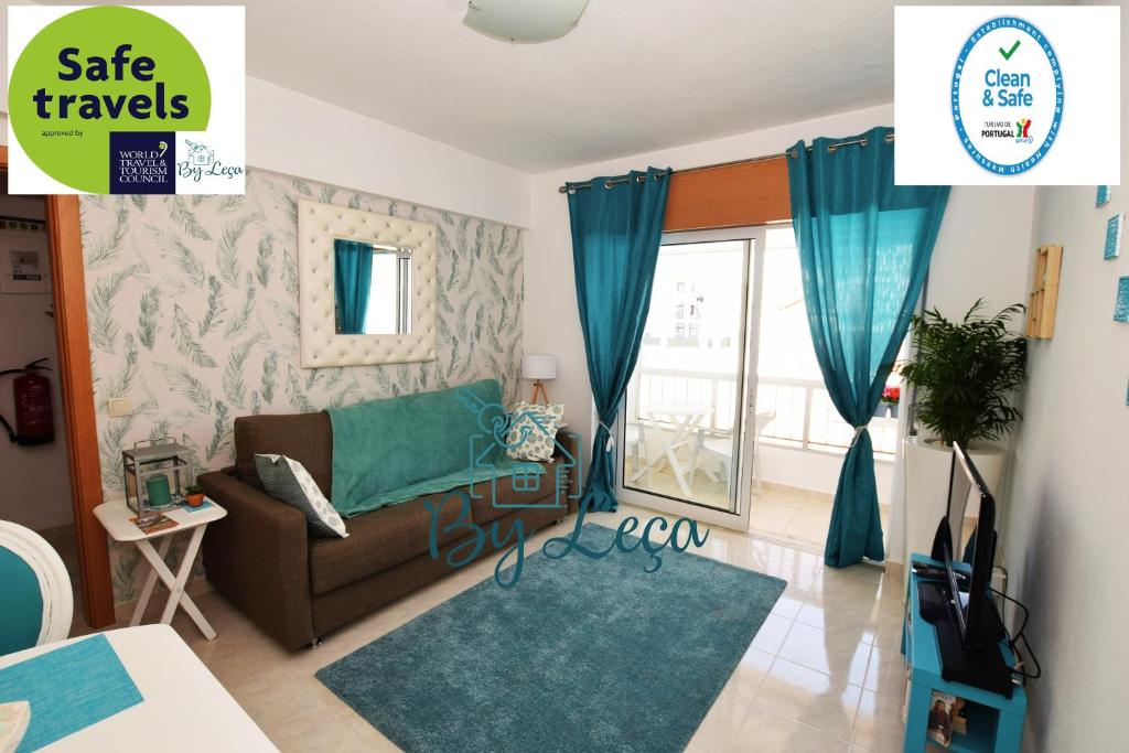 a living room with a couch and a window at Irene's Place in Quarteira