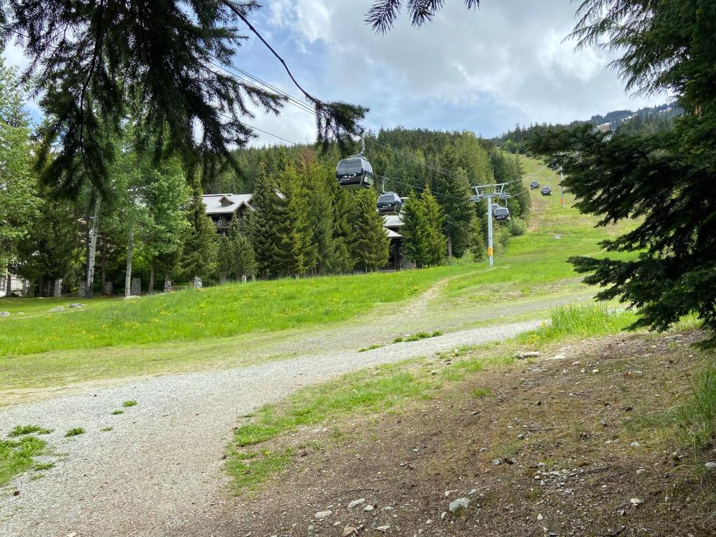 a dirt road with a gondola on a hill at Blackcomb Springs Suites by CLIQUE in Whistler