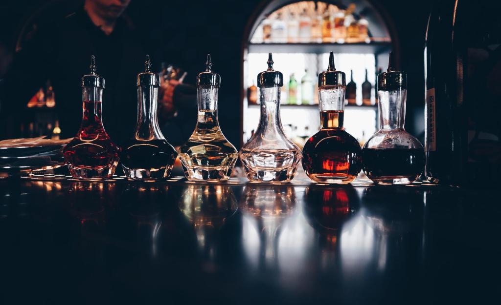 a group of bottles of alcohol sitting on a table at Kimpton Da An Taipei- an IHG Hotel in Taipei