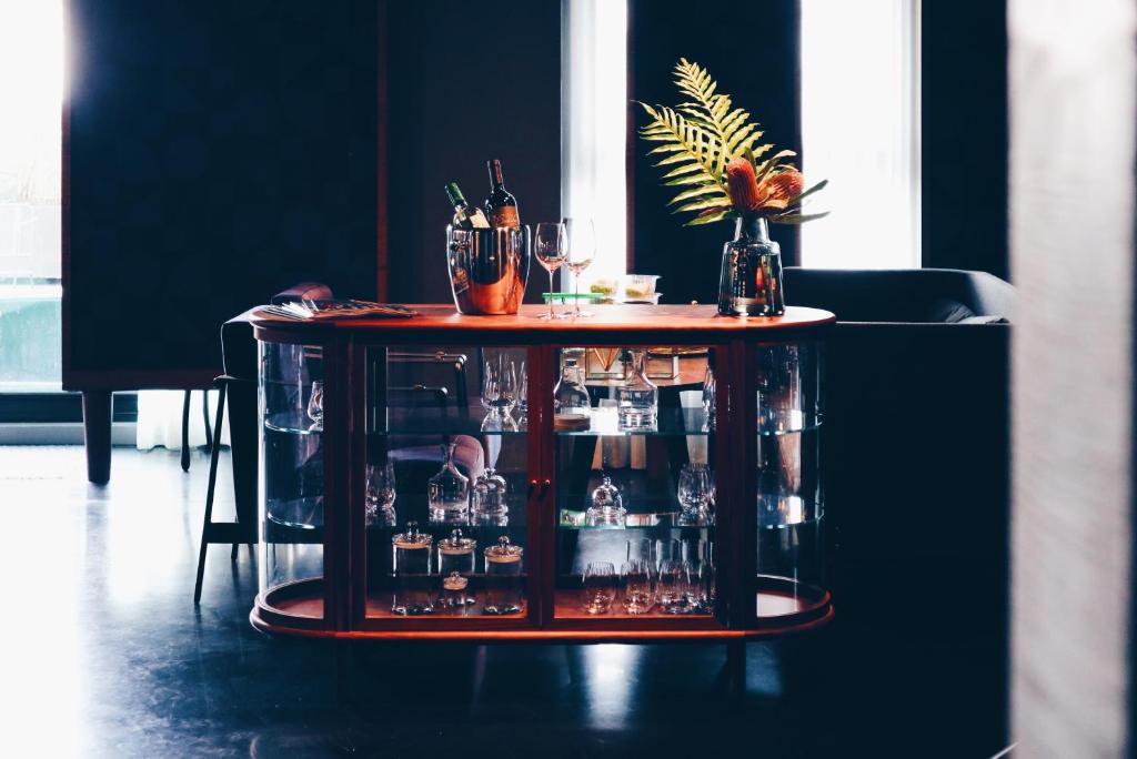 a table with bottles and glasses on it at Kimpton Da An Taipei- an IHG Hotel in Taipei