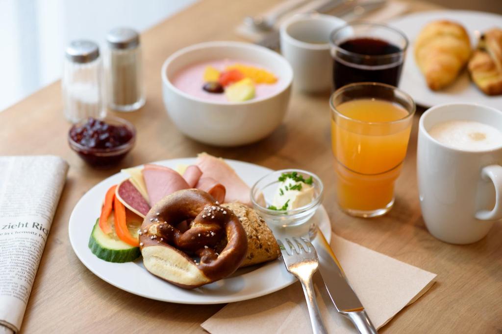un tavolo con un piatto di prodotti per la colazione e bevande di Holiday Inn Express - Goettingen, an IHG Hotel a Gottinga