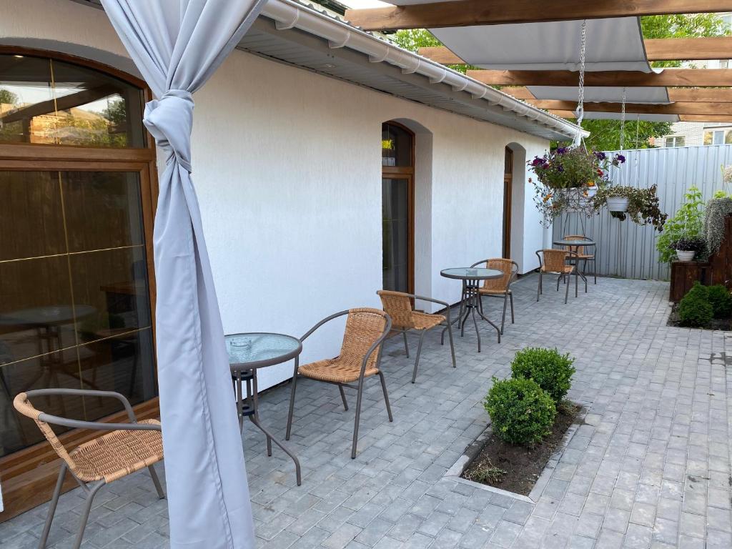 eine Terrasse mit Tischen und Stühlen auf einer Terrasse in der Unterkunft 4rooms in Winnyzja