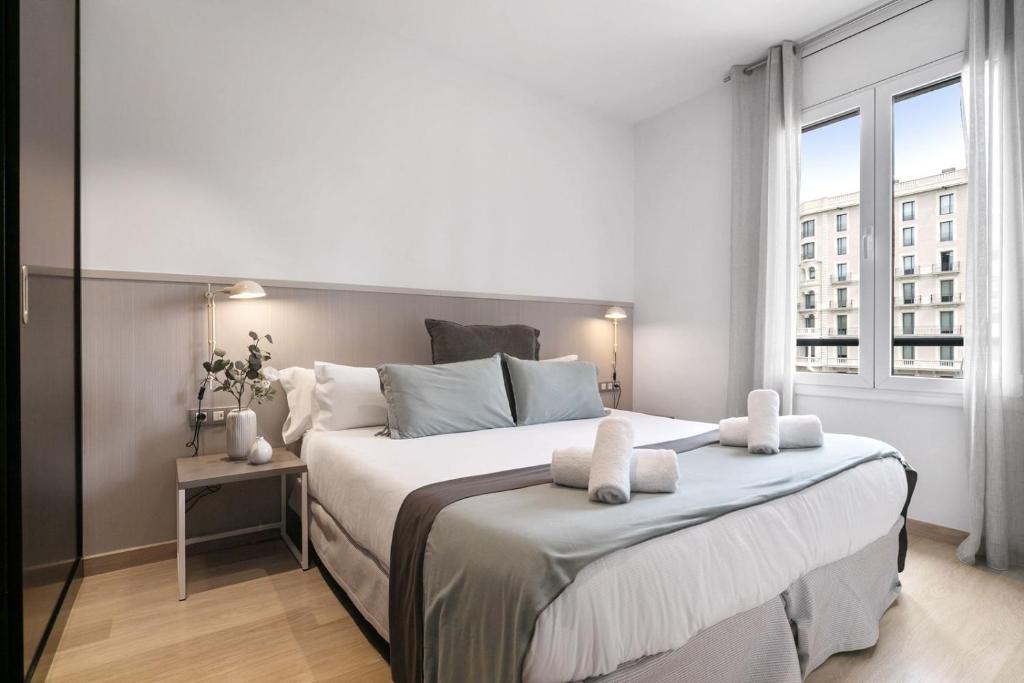 Ένα ή περισσότερα κρεβάτια σε δωμάτιο στο Fisa Rentals Gran Via Apartments