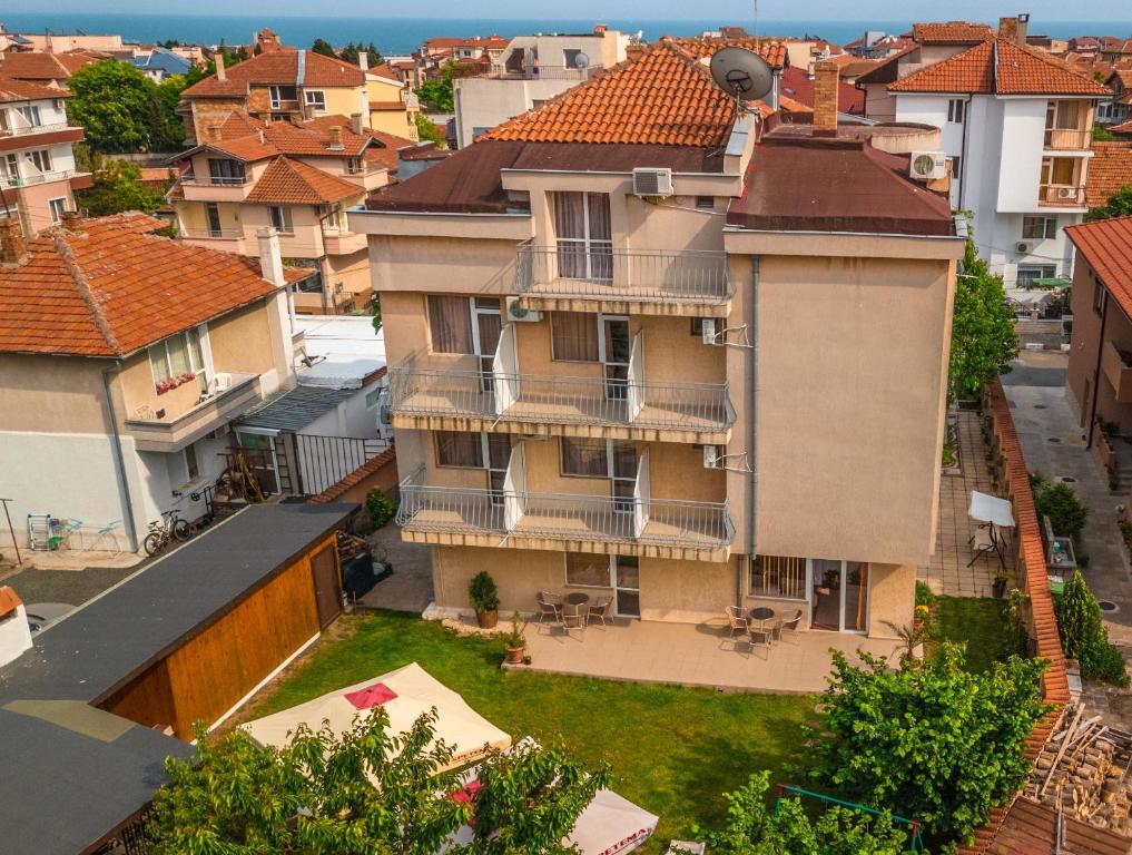 an apartment building with a yard in a city at Vanessa Family Hotel in Ravda
