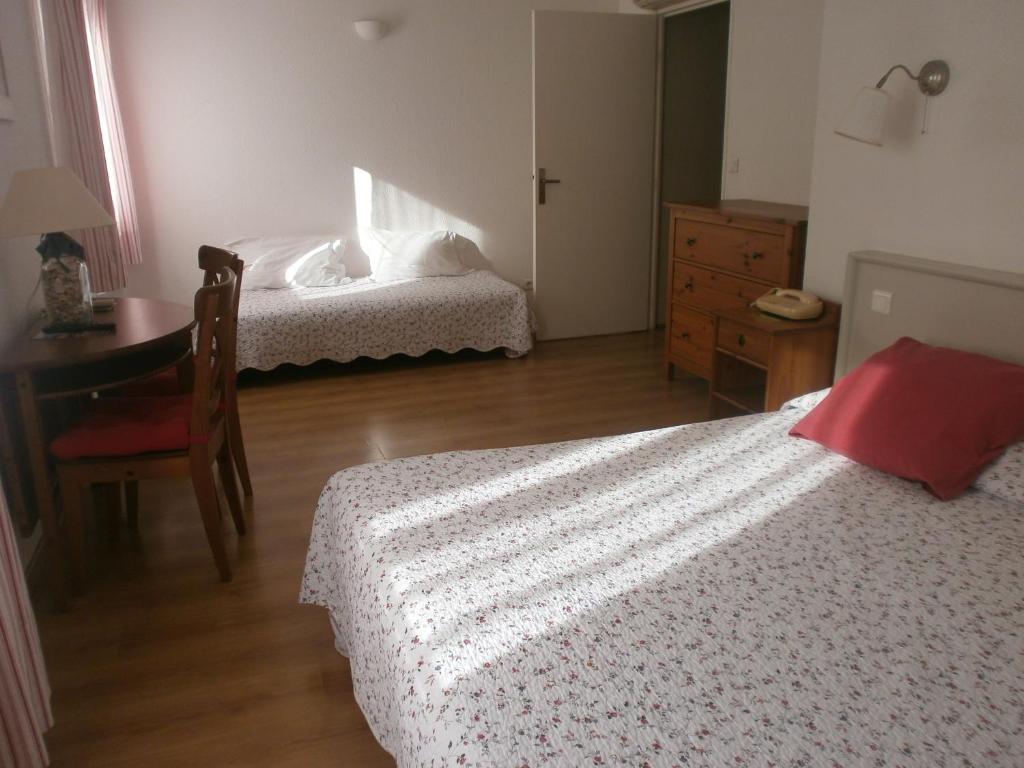 Postel nebo postele na pokoji v ubytování Hôtel Le Clos des Pins