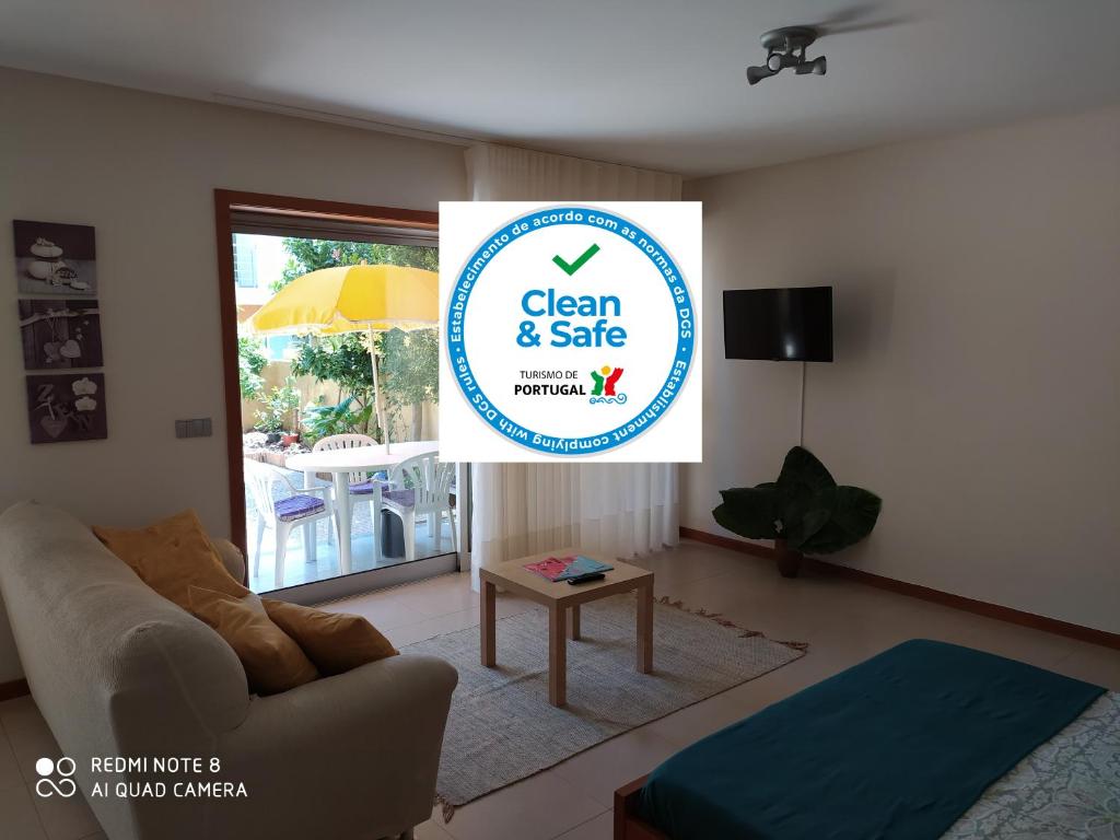 a living room with a sign that says clean and safe at Casa Mosteiro in Braga