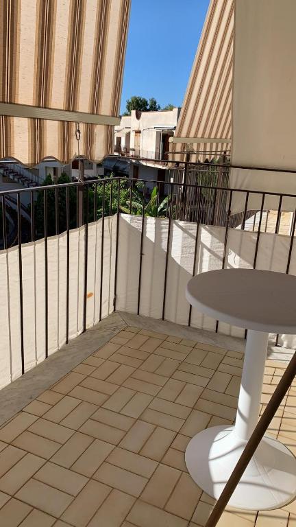 a balcony with a table and a table on a balcony at Home Plutone in Giardini Naxos
